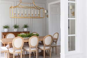 Dining room featuring wood finished floors and a decorative wall