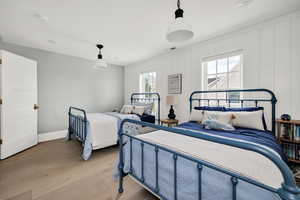 Bedroom featuring wood finished floors and baseboards
