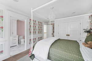 Bedroom with ornamental molding, a closet, and ensuite bath