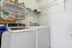 Laundry room with washer and dryer and baseboards