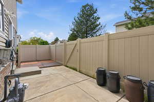 Fenced backyard with a patio