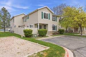 View of front of house with brick siding and uncovered parking