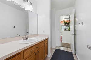 Bathroom with vanity and light tile patterned floors