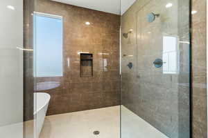 Full bath featuring a freestanding bath and a walk in shower