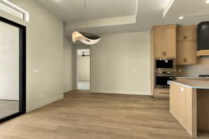 Kitchen with stainless steel appliances, light countertops, light wood-type flooring, recessed lighting, and light wood finish cabinets