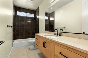 Bathroom featuring vanity, bathing tub / shower combination, recessed lighting, and light tile patterned floors