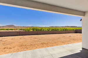 Fenced backyard featuring a mountain view