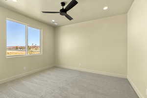 Empty room featuring ceiling fan, light carpet, and recessed lighting