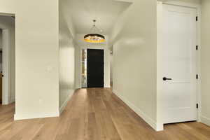 Foyer entrance featuring a chandelier and light wood-type flooring