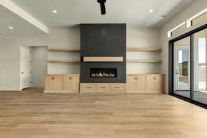 Unfurnished living room with recessed lighting, a fireplace, light wood-style floors, and ceiling fan
