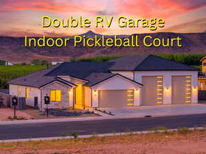 View of front of property featuring a garage, stone siding, concrete driveway, and stucco siding