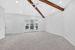 Unfurnished living room featuring a ceiling fan, carpet flooring, vaulted ceiling, and recessed lighting