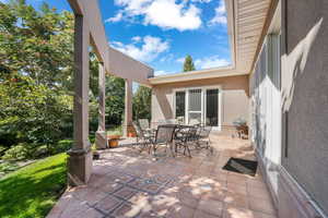 View of patio with outdoor dining area and a grill