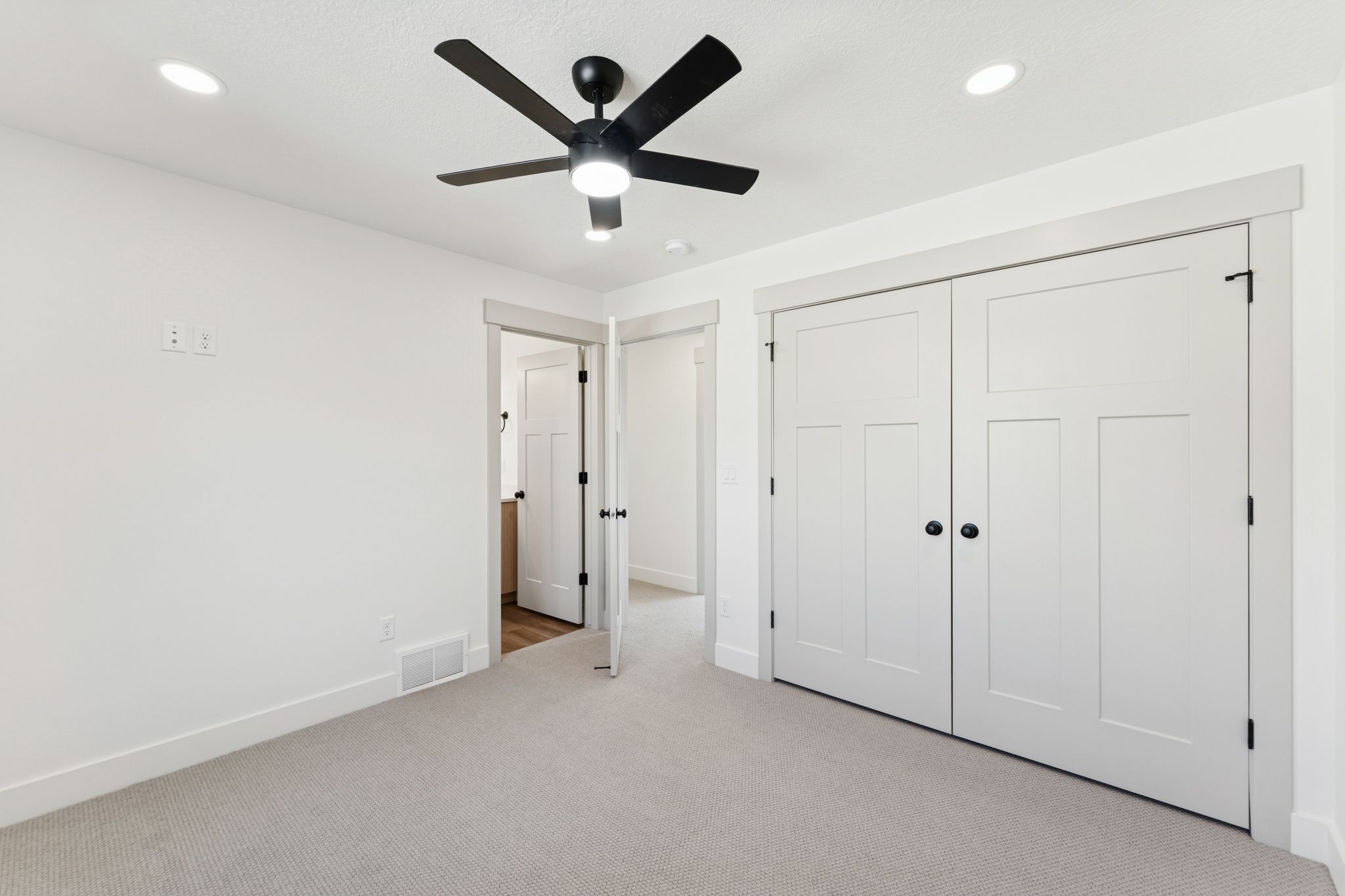 Unfurnished bedroom with light colored carpet, a closet, a ceiling fan, and recessed lighting