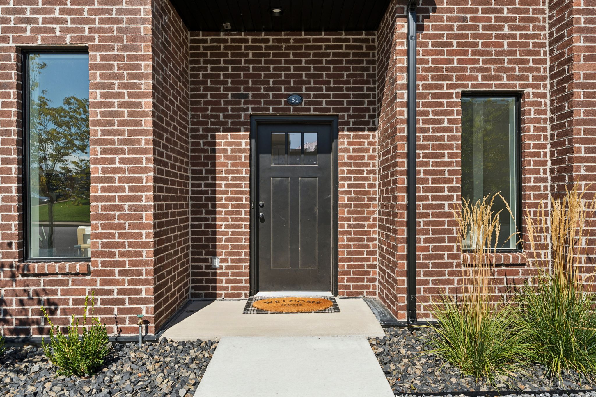 Doorway to property featuring brick siding
