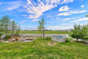Fenced backyard with a patio