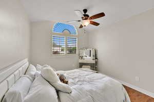 Bedroom featuring a ceiling fan and wood finished floors