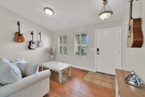 Foyer entrance with light wood finished floors and baseboards
