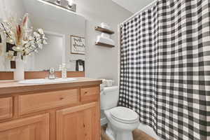 Bathroom featuring vanity, a shower with shower curtain, and tile patterned floors