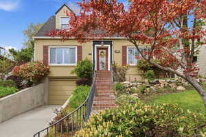 View of front of home with an attached garage, brick siding, driveway, and a shingled roof