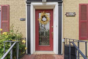 Entrance to property featuring brick siding