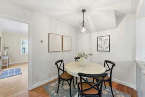 Dining space featuring light wood-type flooring and crown molding