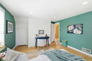 Bedroom with light wood-type flooring, recessed lighting, and multiple windows