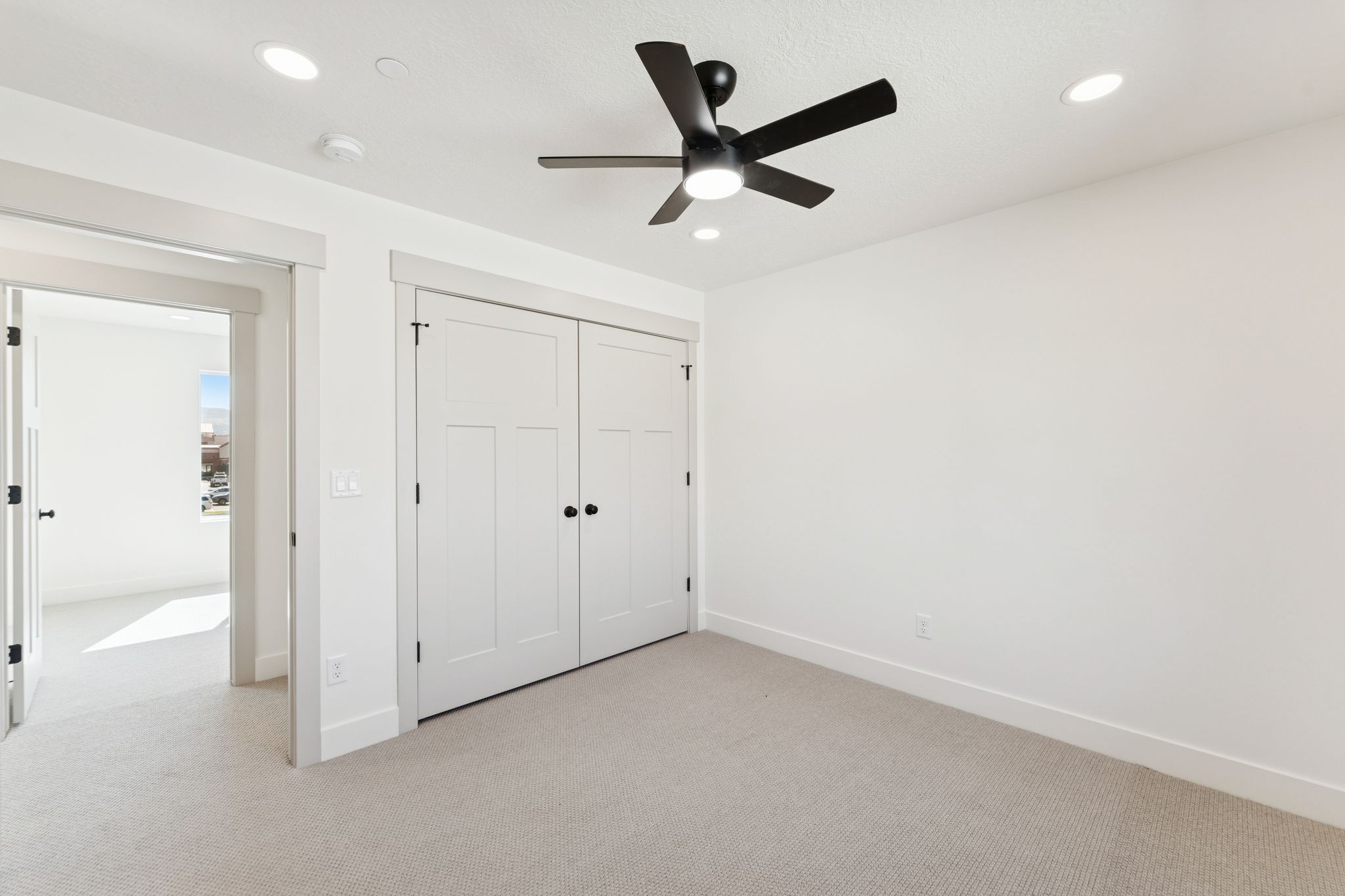 Unfurnished bedroom featuring light carpet, a closet, a ceiling fan, and recessed lighting