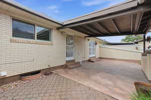 View of patio / terrace featuring entry steps and an attached carport.