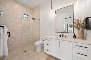 Full bathroom with vanity, walk in shower, and light tile patterned flooring