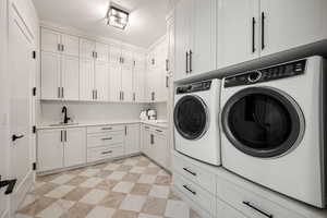 Laundry area featuring cabinet space and washer and dryer