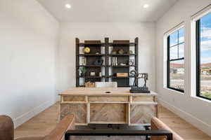 Office featuring light wood finished floors and recessed lighting