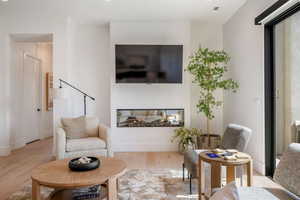 Living area with light wood-style flooring and baseboards