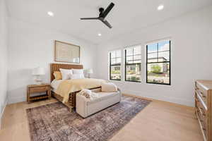 Bedroom with light wood finished floors, a ceiling fan, and recessed lighting