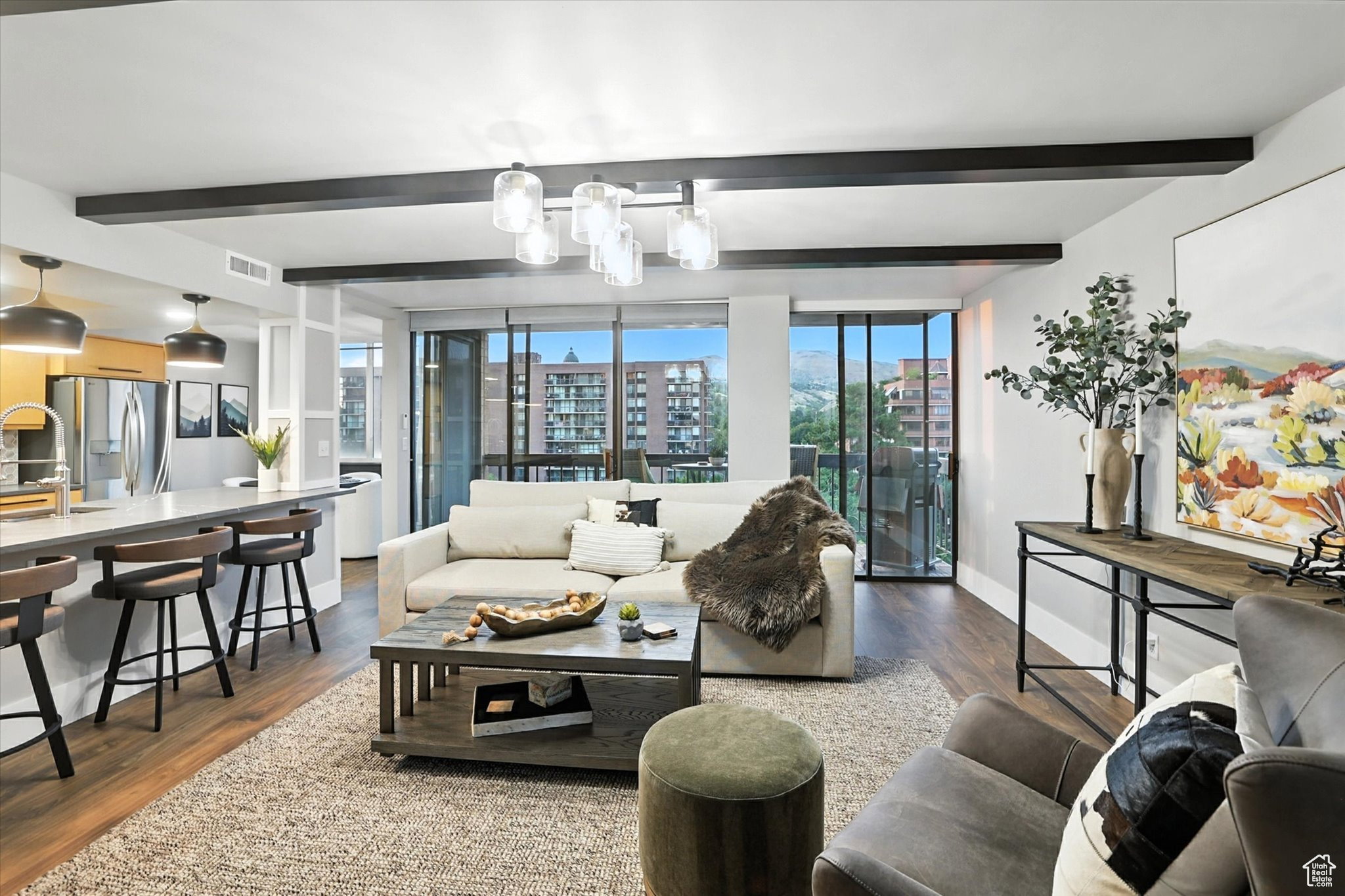 Living room with beam ceiling and city view
