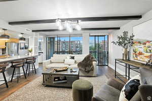 Living room with beam ceiling and city view