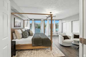 Top floor bedroom suite featuring a chandelier, multiple closets, and access to the roof top deck