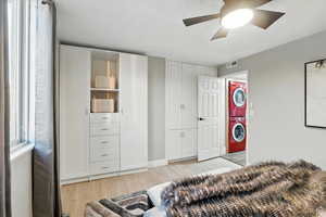 Bedroom on main level featuring stacked washer and dryer.