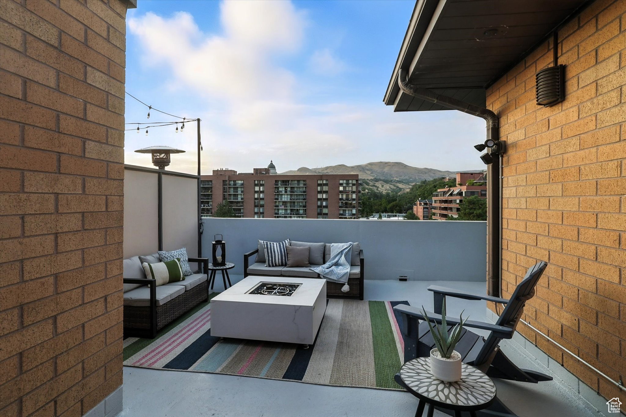 Private roof top deck with an outdoor living space with a fire pit and a mountain view