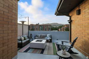 Balcony with an outdoor living space with a fire pit and a mountain view