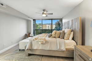 Bedroom on main floor featuring expansive windows with eastern mountain views