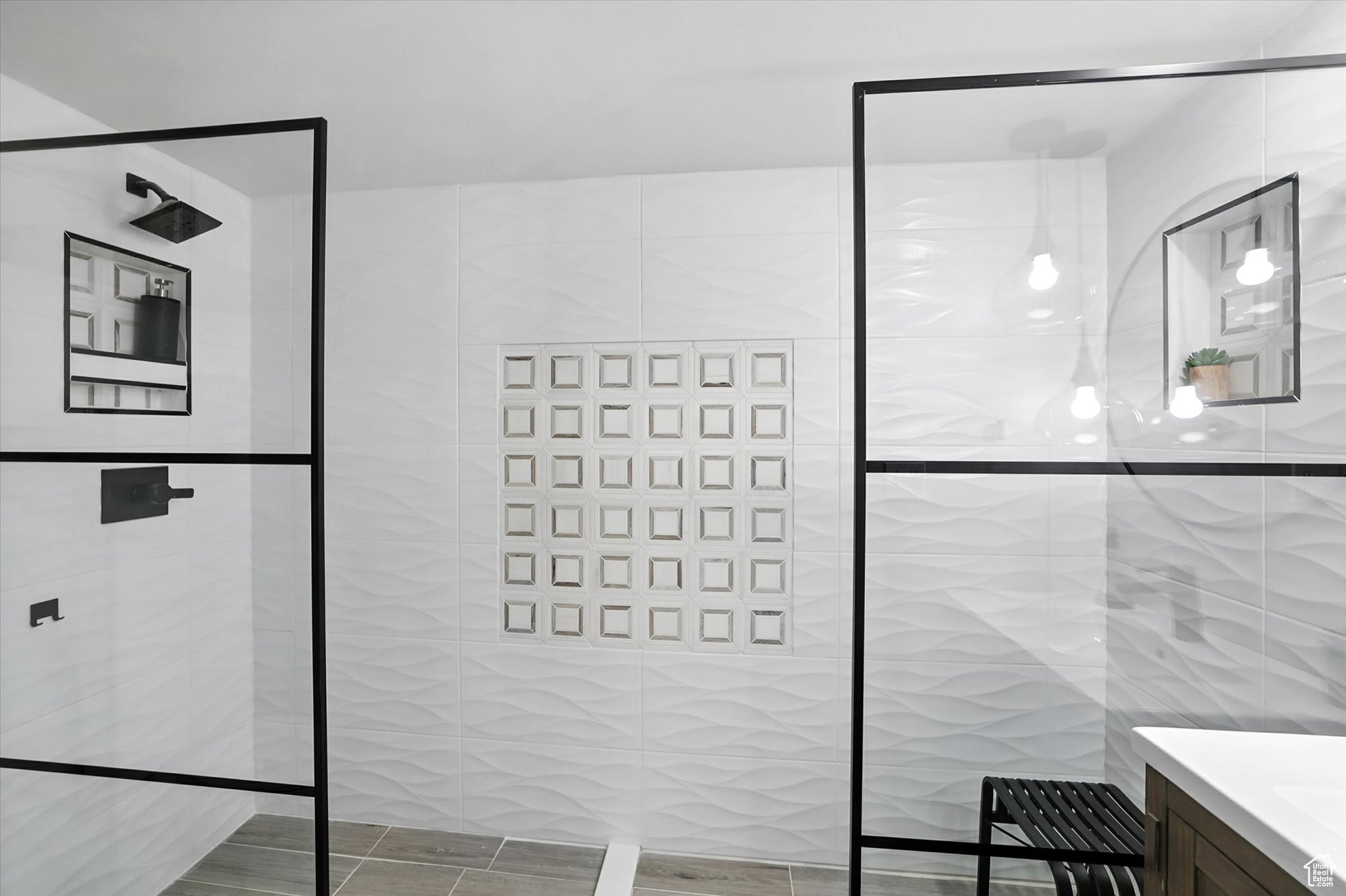Bathroom suite with tile walls, vanity, and a walk in shower