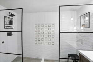Bathroom suite with tile walls, vanity, and a walk in shower