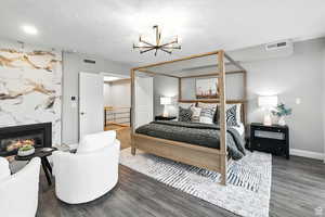 Top floor bedroom suite with a chandelier, and a premium gas fireplace
