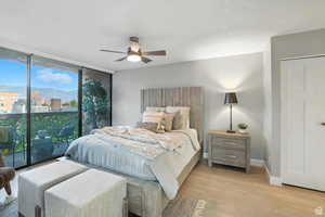 Bedroom on main floor with floor to ceiling windows with access to outside deck with eastern mountain views.
