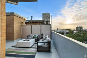Balcony with an outdoor living space with a fire pit and a city view