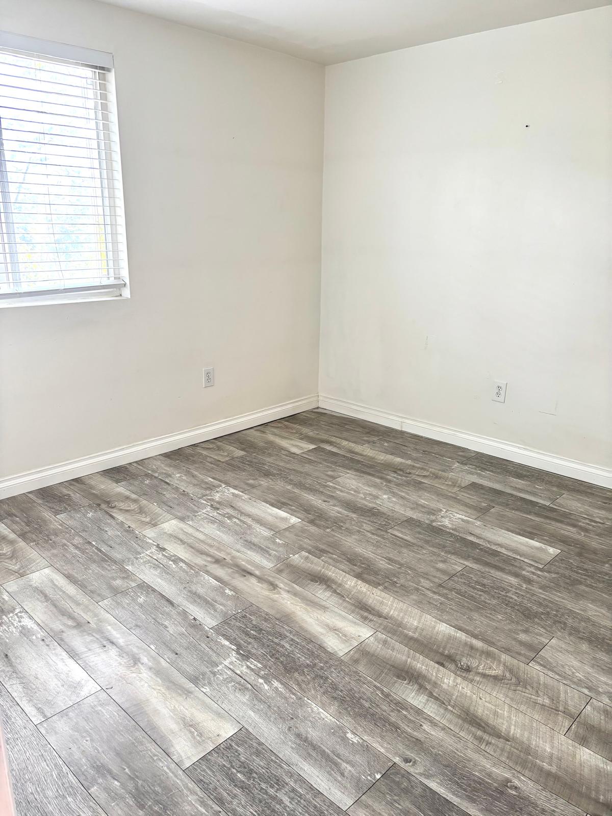 Spare room with wood finished floors and baseboards
