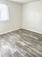 Spare room with wood finished floors and baseboards