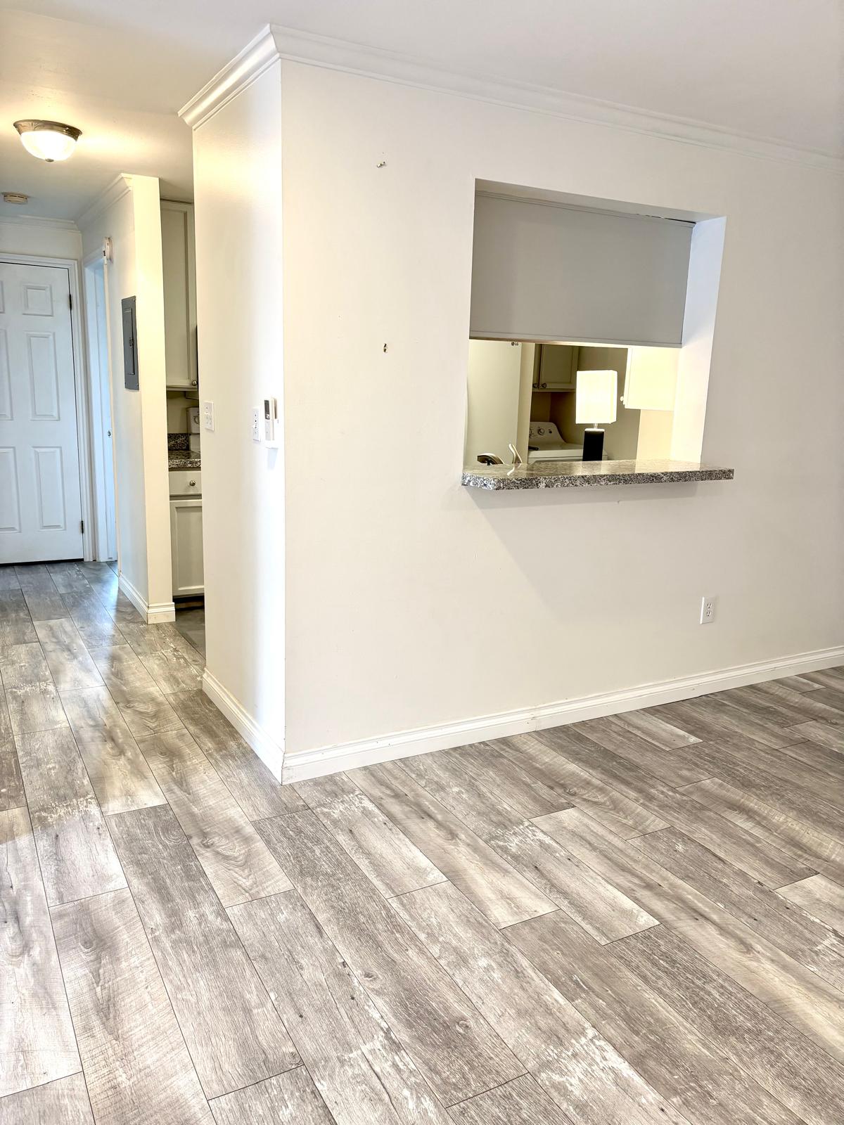 Unfurnished room with crown molding and light wood-style flooring