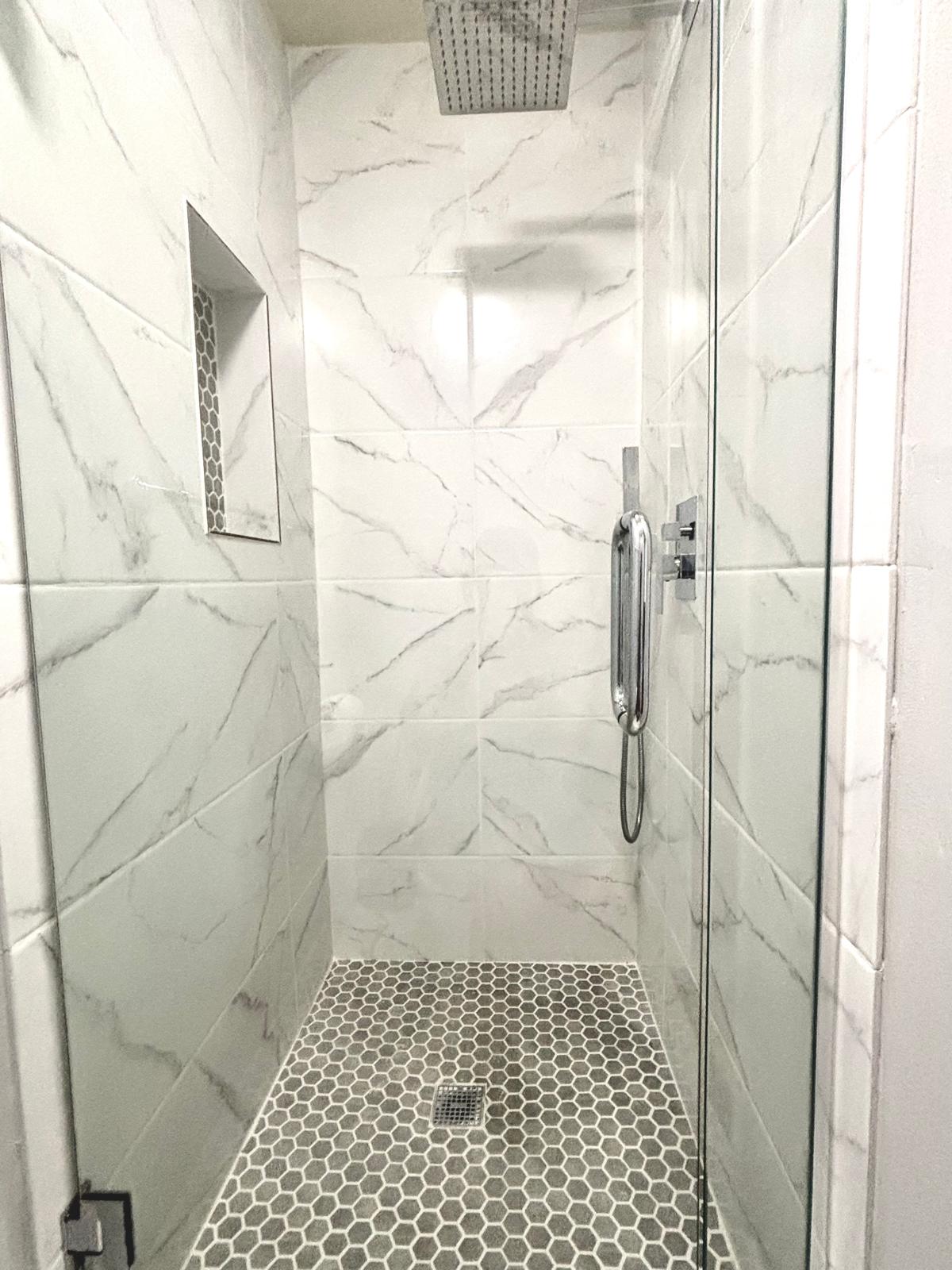 Bathroom featuring a marble finish shower